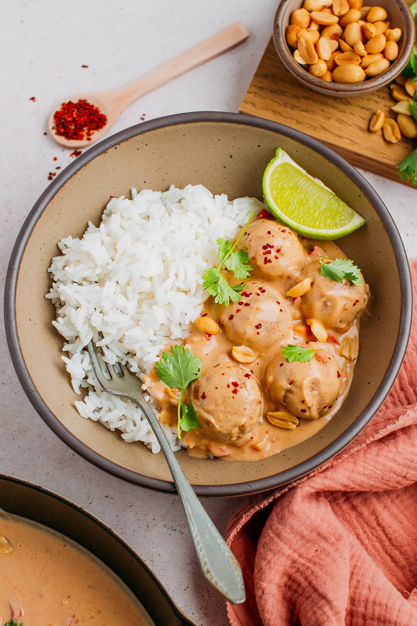 Fonio balls in peanut sauce with rice in a bowl.