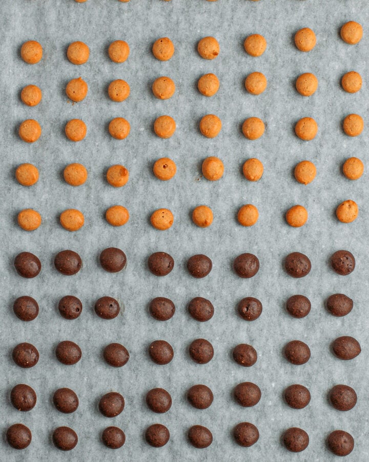 Baked peanut butter and chocolate cereal on a baking sheet.