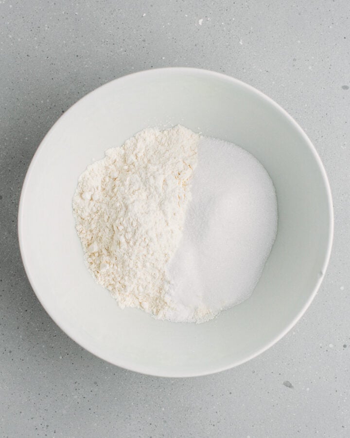 Flour, sugar, baking powder, and baking soda in a bowl.