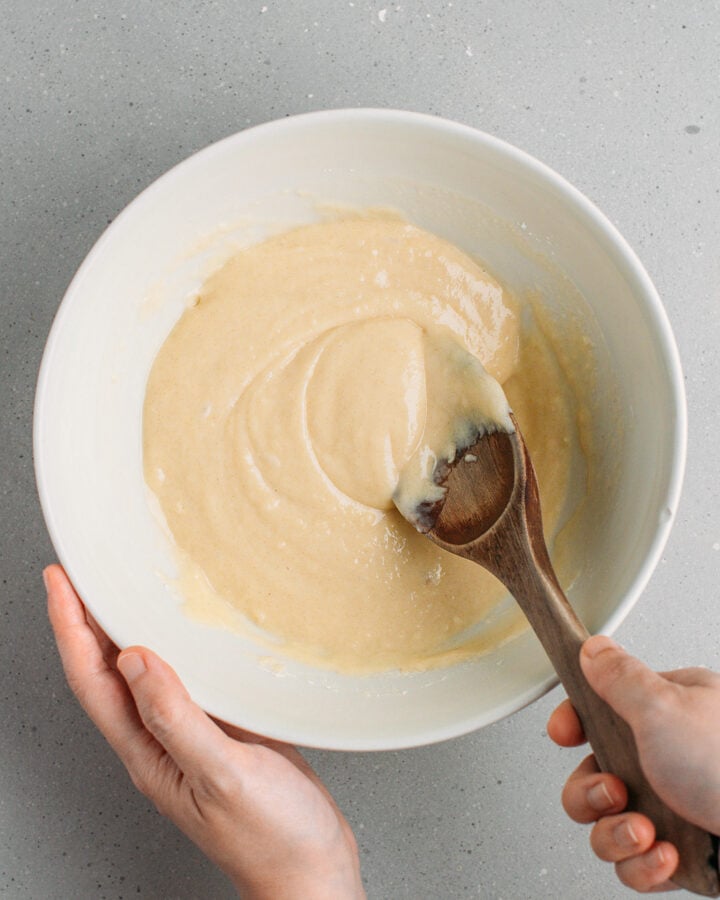 Mixing a cereal batter in a bowl.