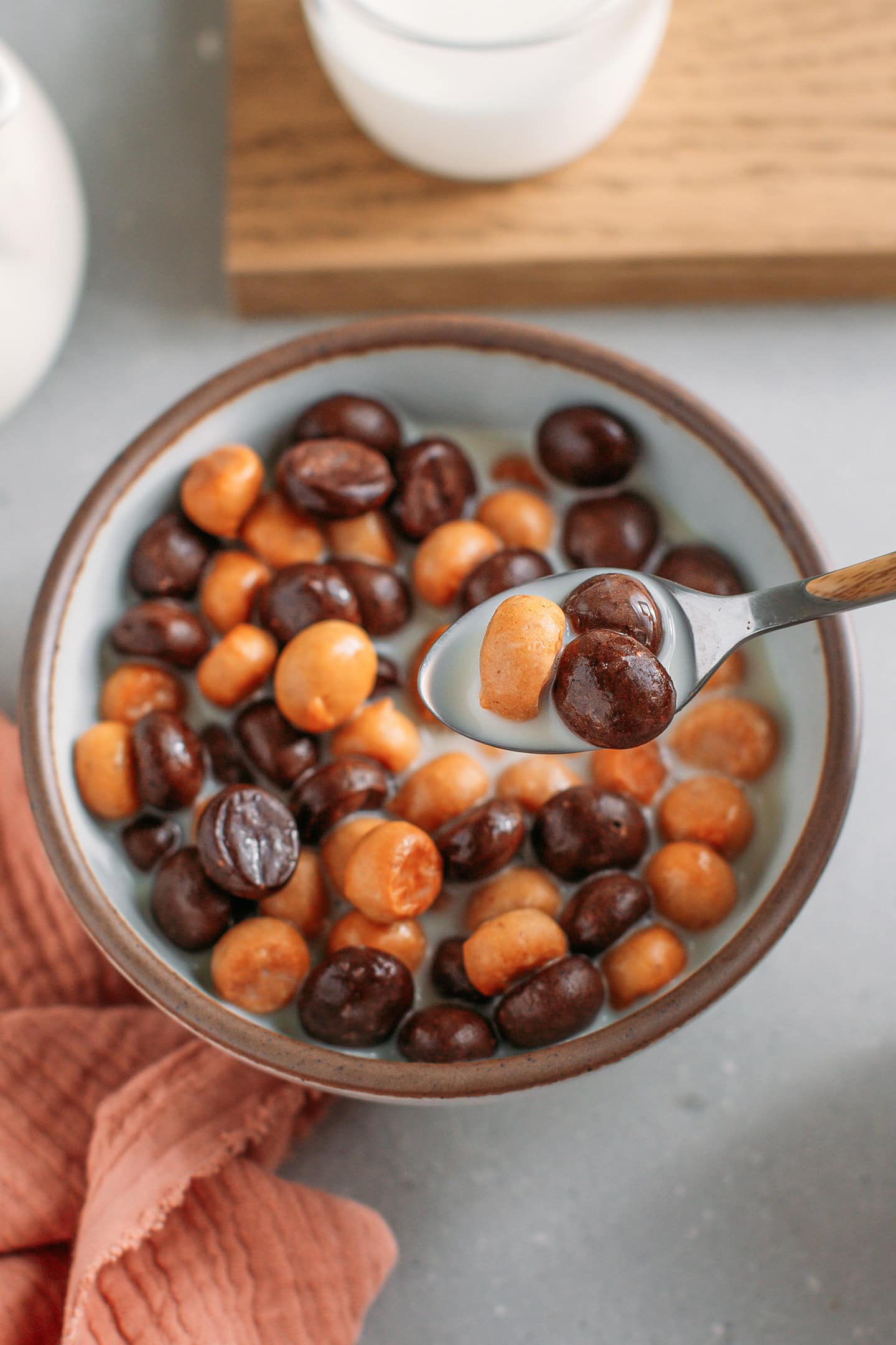Spoonful of chocolate and peanut butter cereal over a bowl.