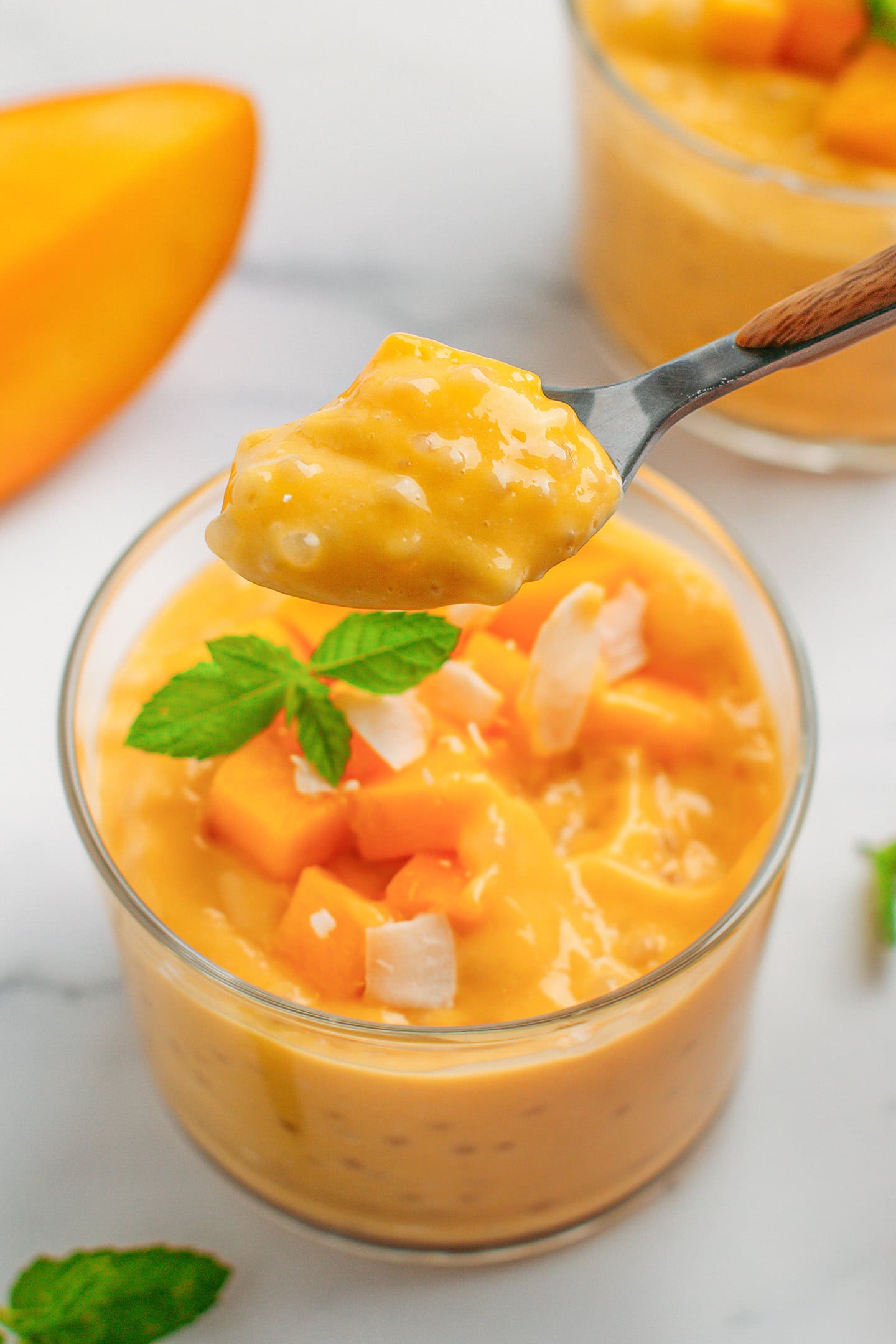 Close-up of a spoonful of mango sago.