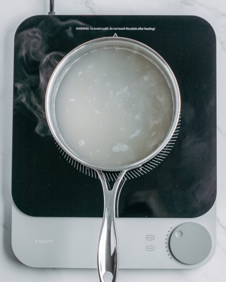 Tapioca pearls cooking in a pot of boiling water.