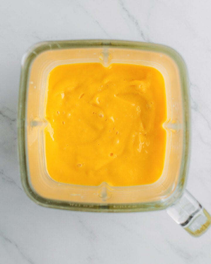 Blended mango and coconut milk in a blender.