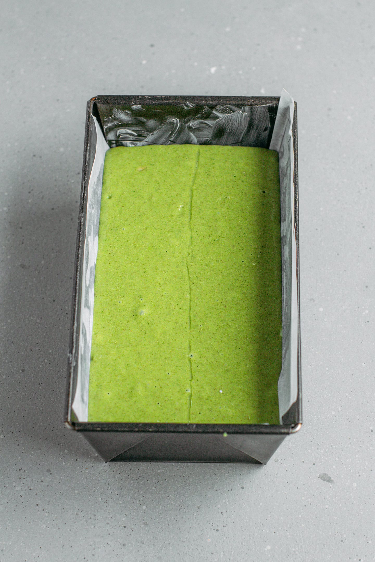 Pandan cake batter in a loaf pan.
