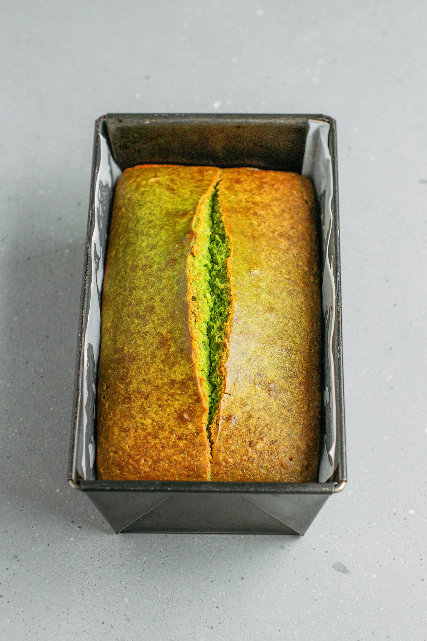 Baked pandan coconut bread in a loaf pan.