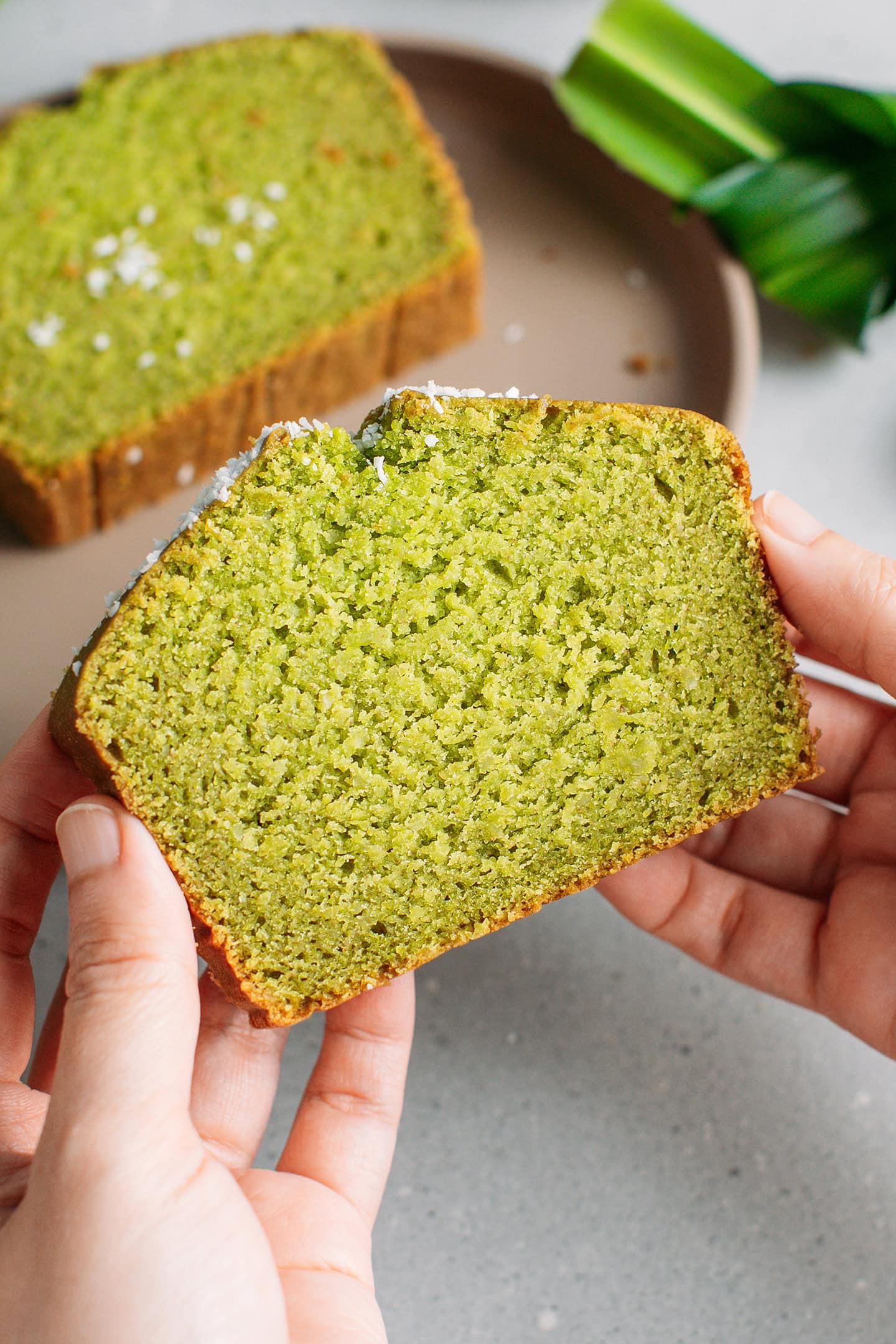 Holding a slice of pandan bread.