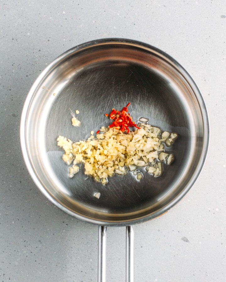 Minced garlic, chili, and ginger in a saucepan.