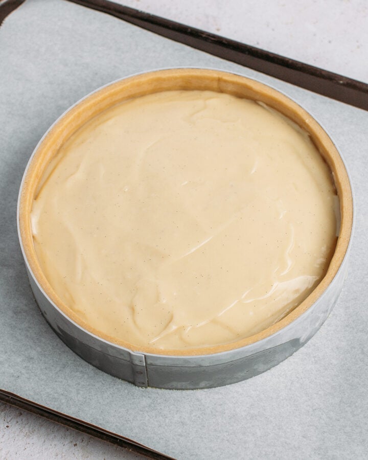 Pouring vanilla custard into a crust.