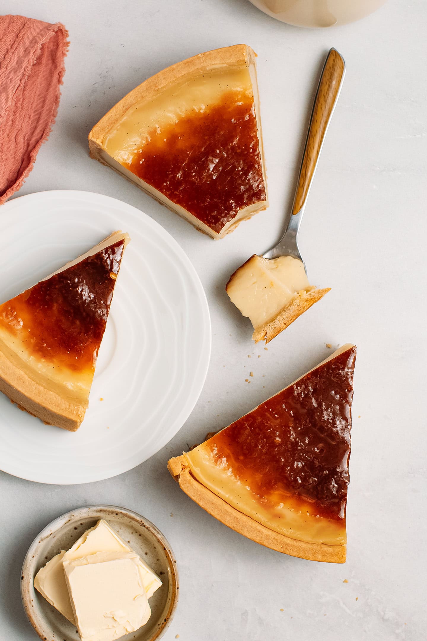 Three slices of vegan custard tart on a grey background.
