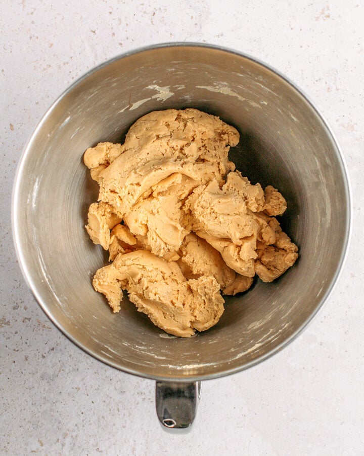 Pie crust dough in a stand mixer bowl.