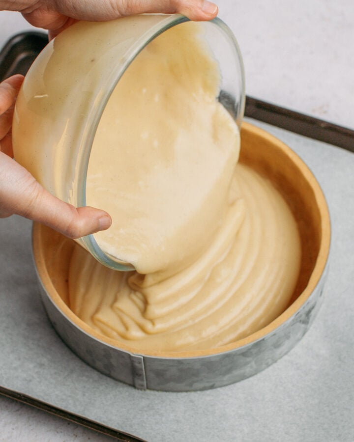 Pouring vanilla custard into a crust.