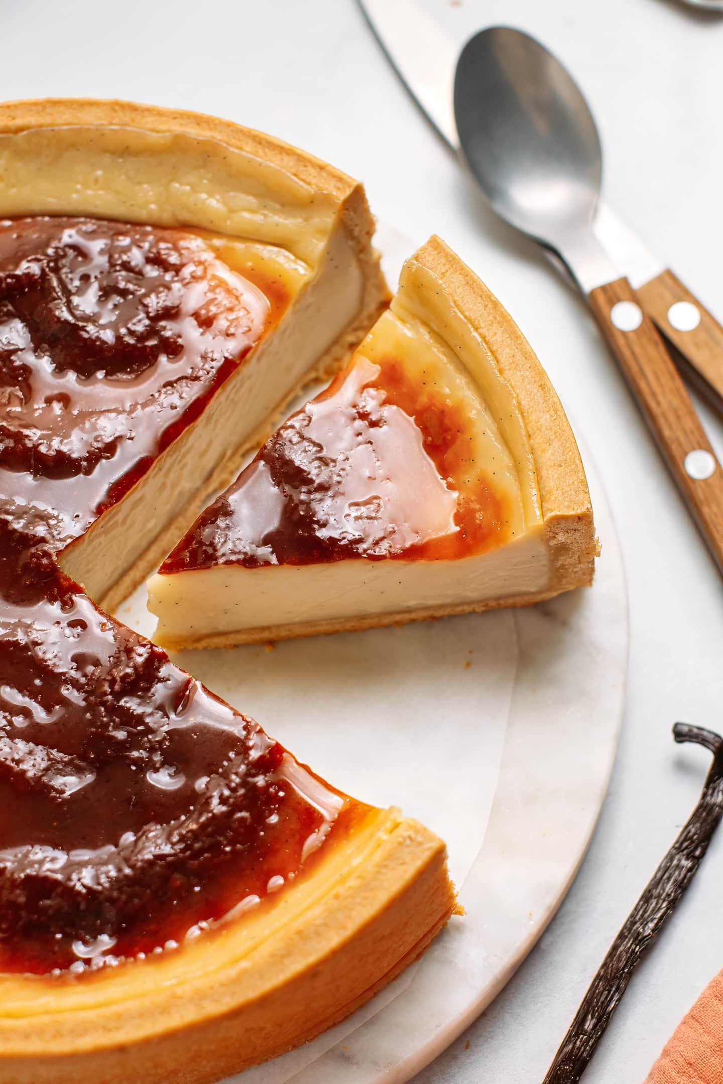 Slice of vegan custard tart on a marble plate.