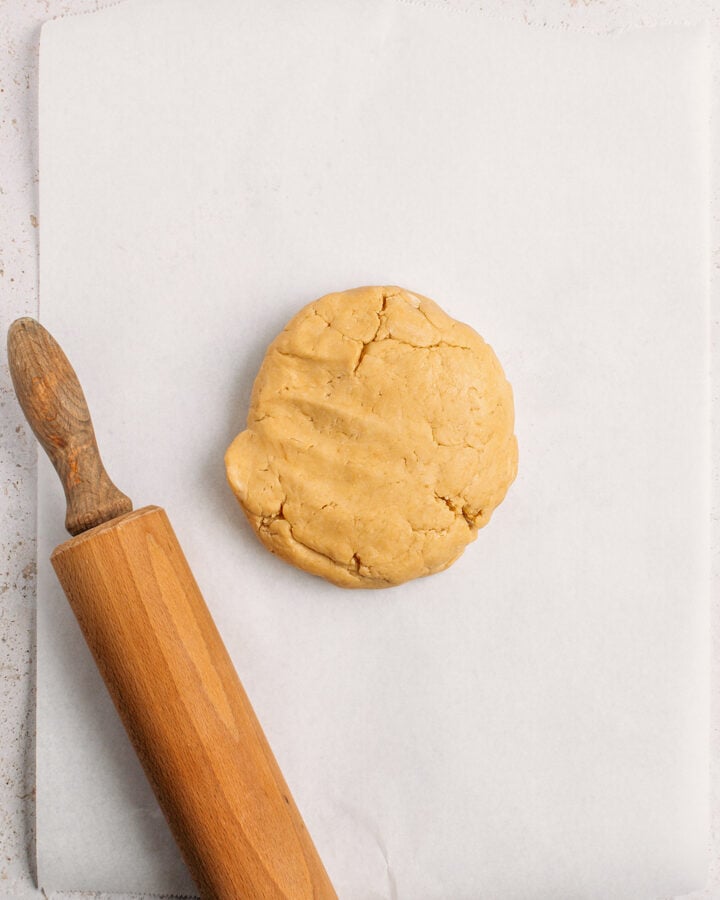 Ball of dough on a sheet of parchment paper.