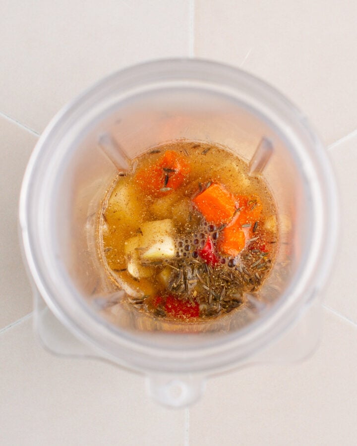 Fresh turmeric, chili, garlic, and shallots in a blender.