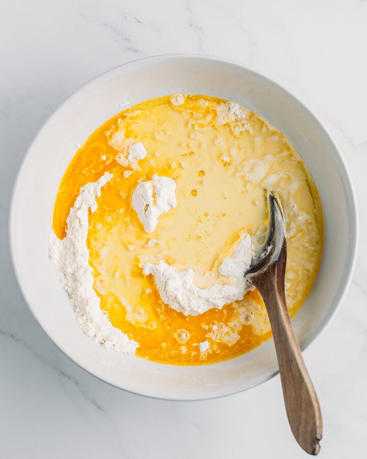 Flour, melted butter, oil, and vanilla extract in a mixing bowl.