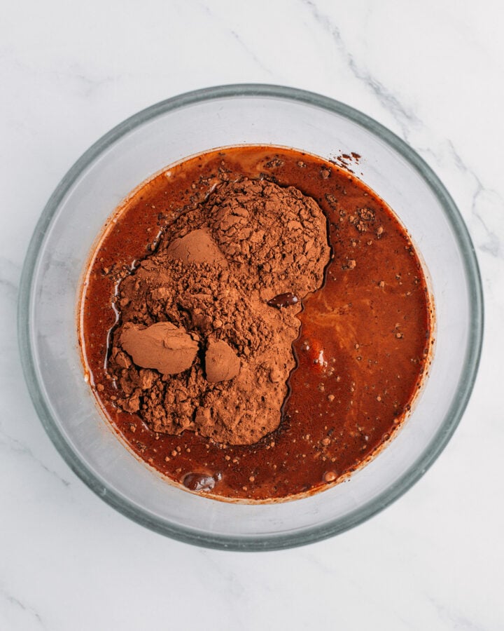 Cake batter, cocoa powder, and espresso in a small mixing bowl.
