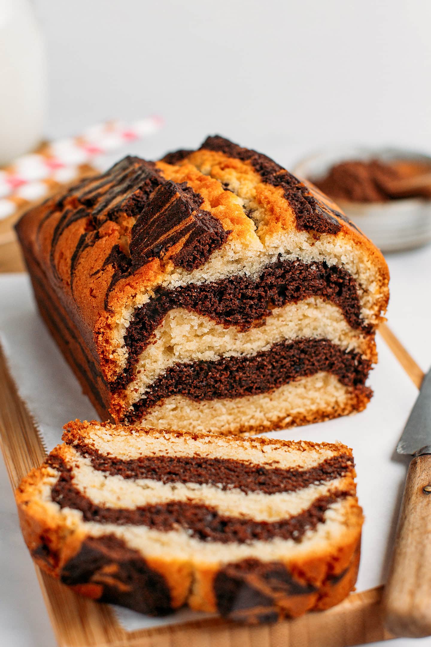 Marble cake with chocolate and vanilla layers on a cutting board.