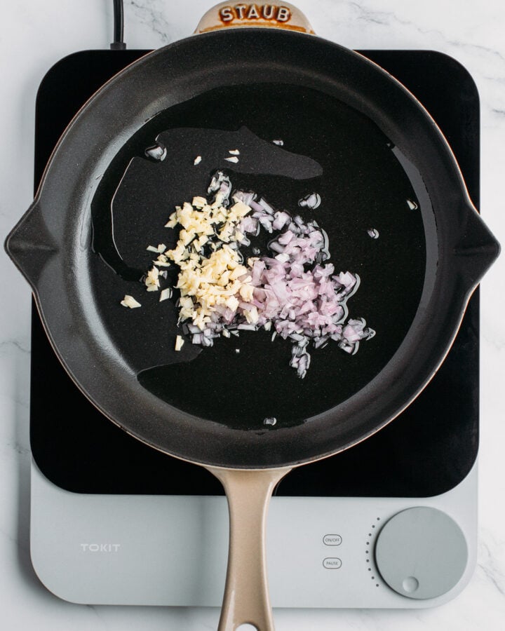 Minced garlic and shallots in a skillet.