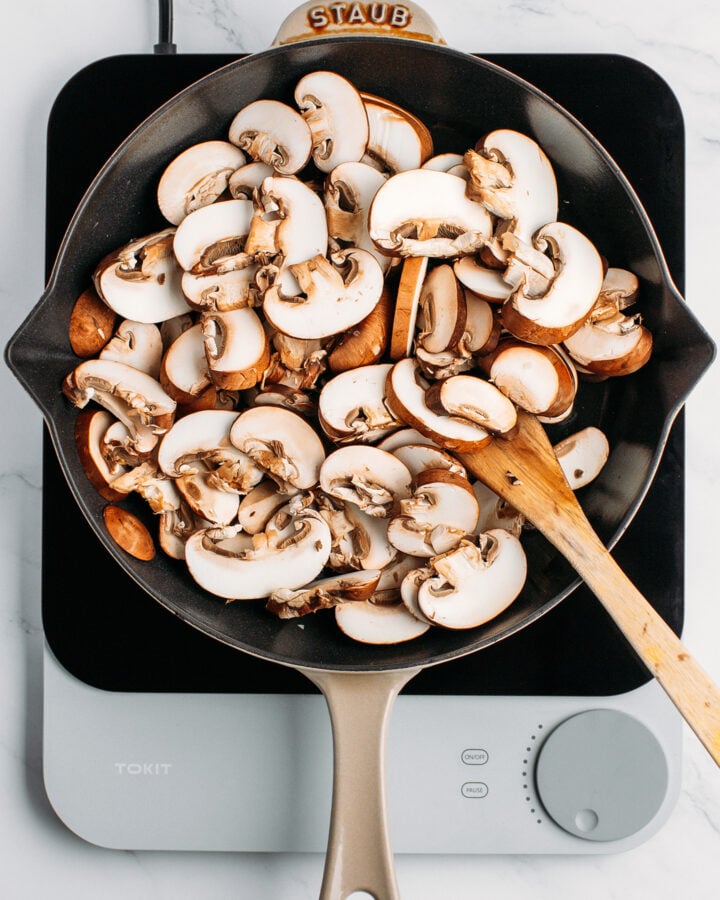 Sliced mushrooms in a skillet.