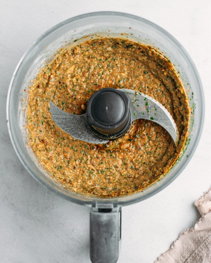 Processed white beans with seasonings in a food processor.