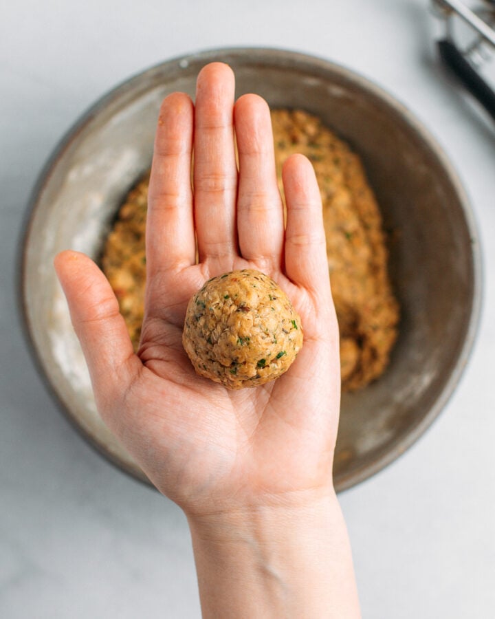 Holding a vegan meatball.