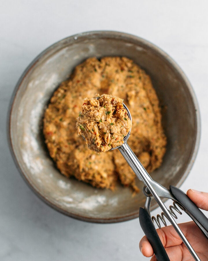 Scooping vegan ground meat mixture using a cookie scoop.