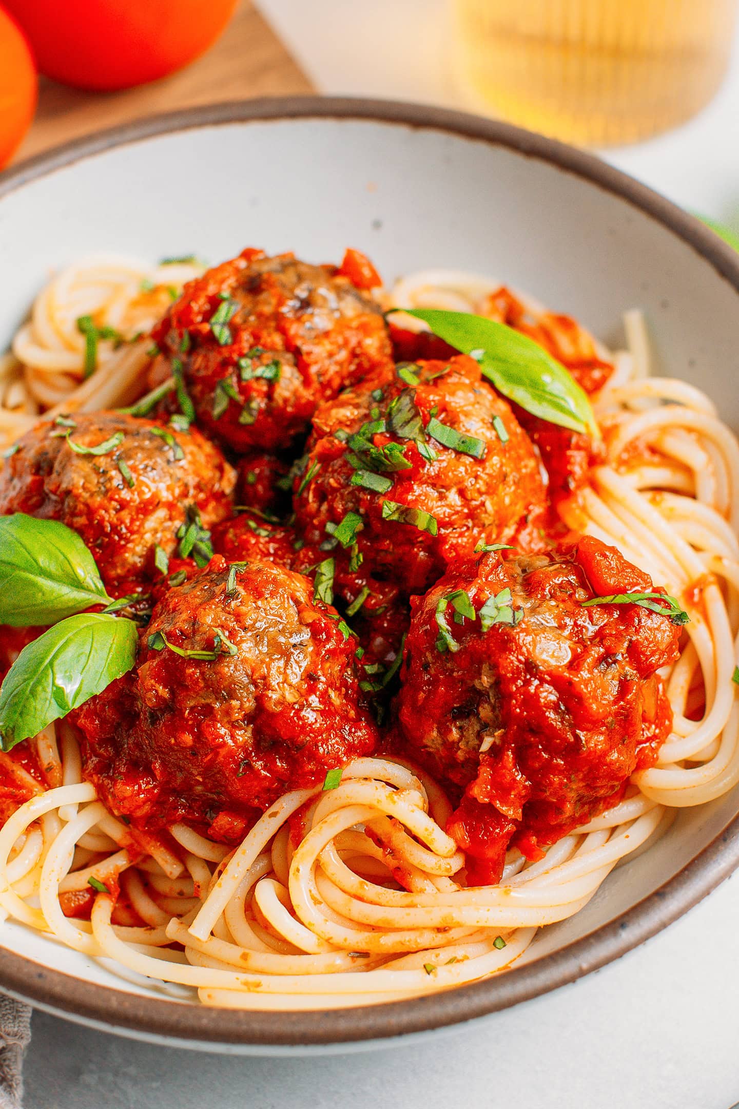 Close-up of vegan meatballs with tomato sauce over spaghetti.
