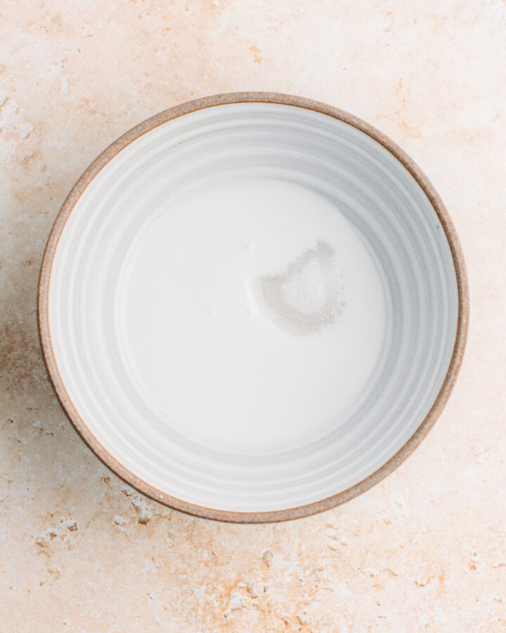 Coconut milk, sugar, and salt in a bowl.