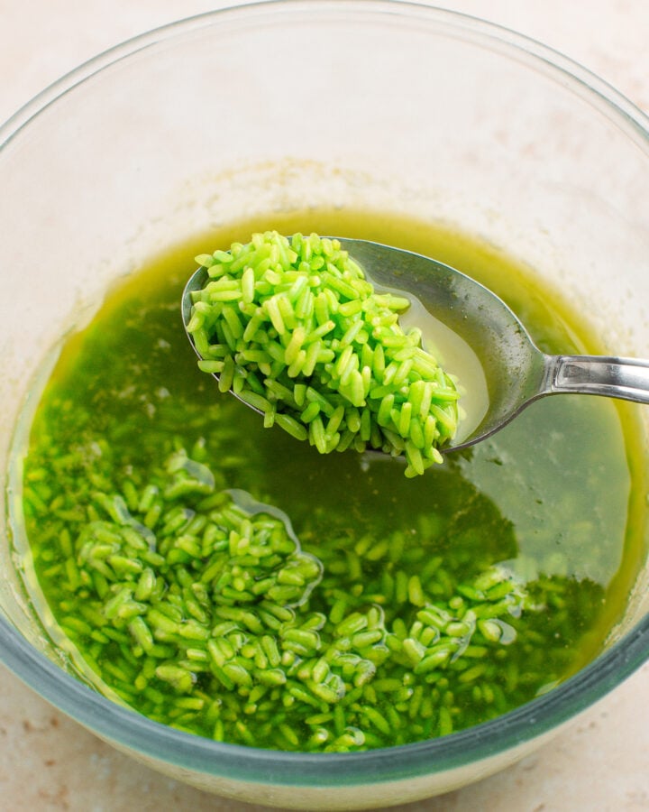 Spoonful of soaked pandan rice.