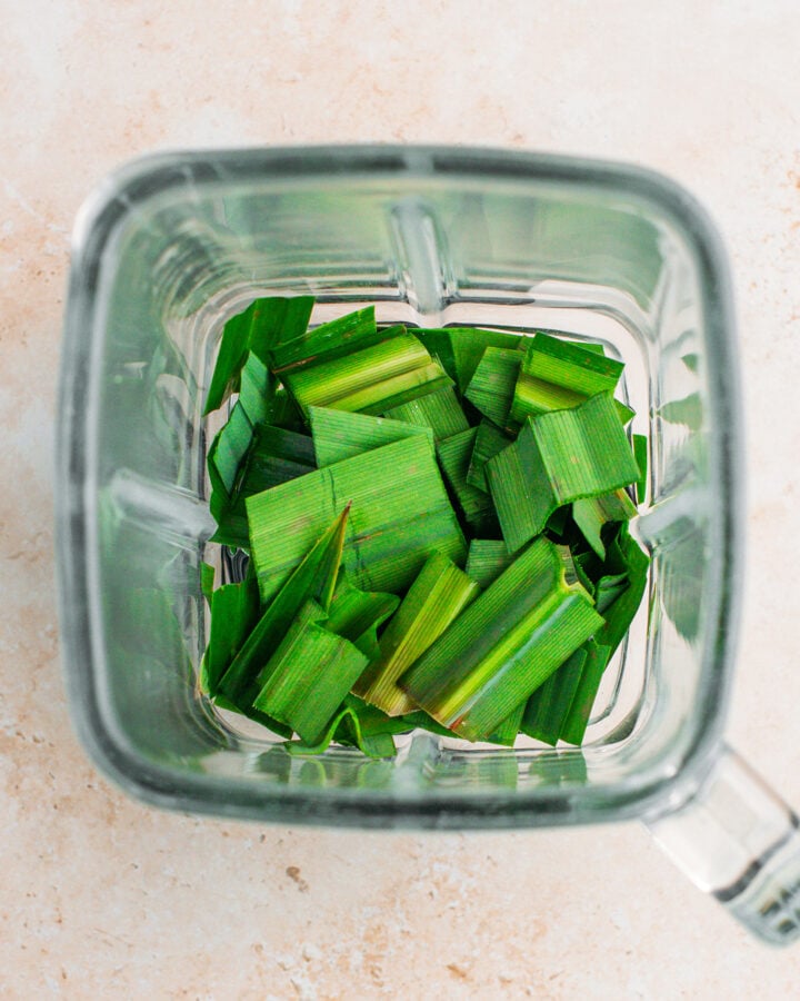 Chopped pandan leaves and water in a blender.