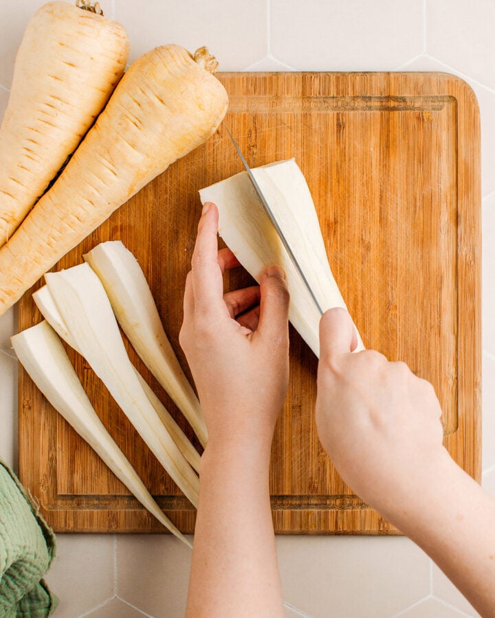 Slicing a parsnip in half.