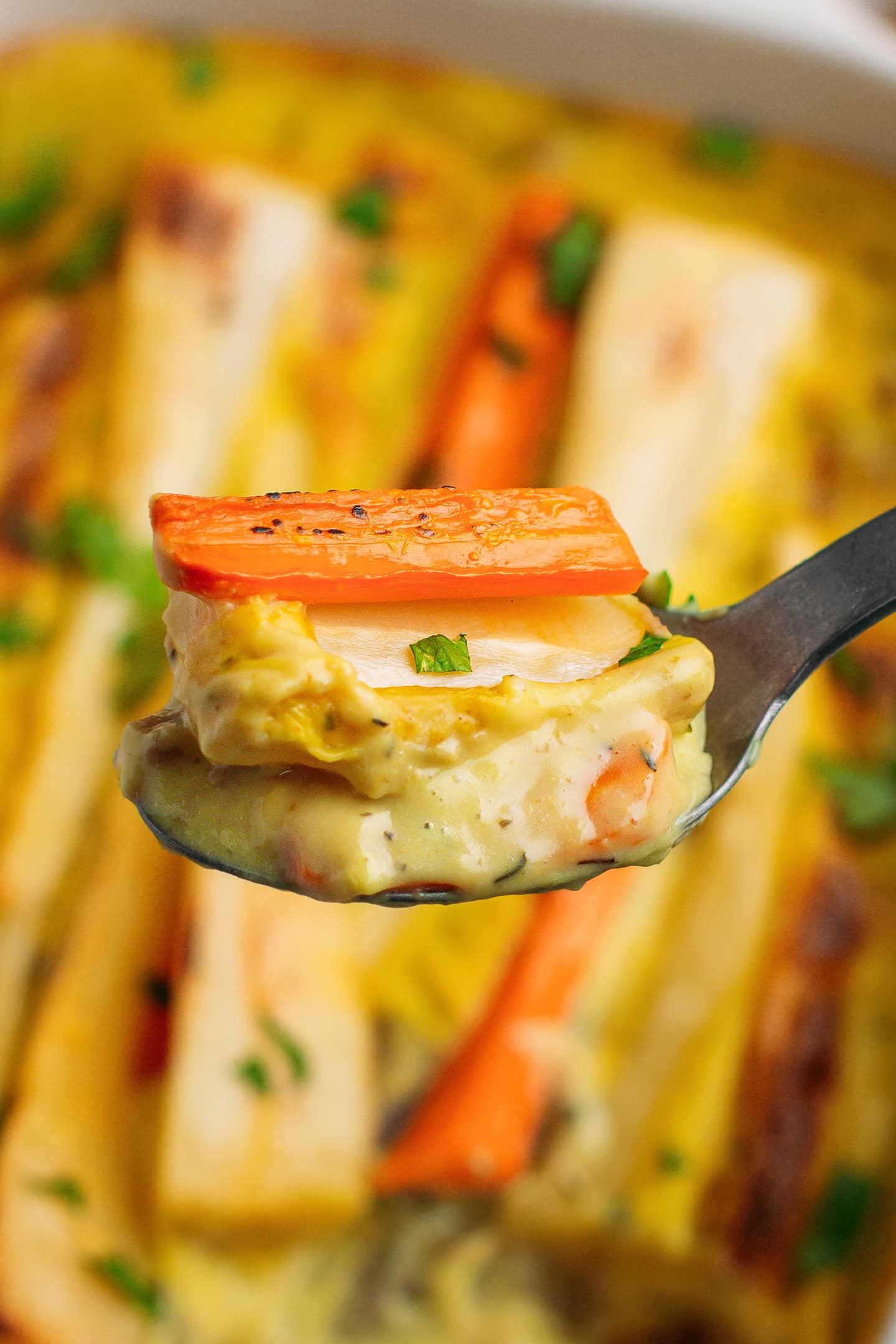 Close-up of a spoonful of parsnip and carrot bake.