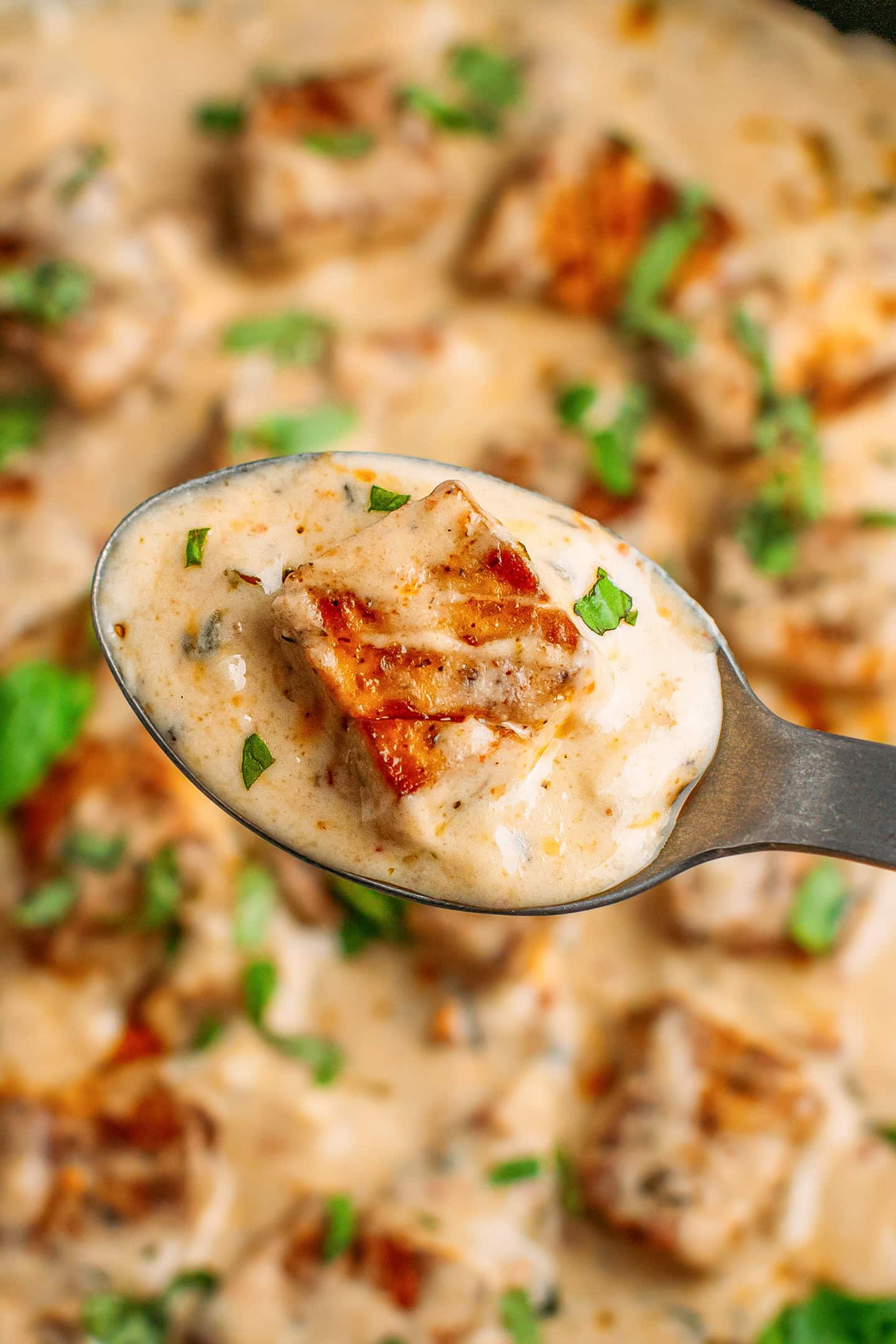 Holding a spoonful of marry me tofu.