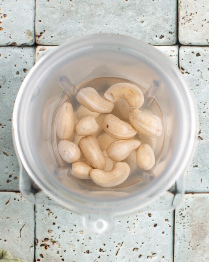 Raw cashews in a blender.