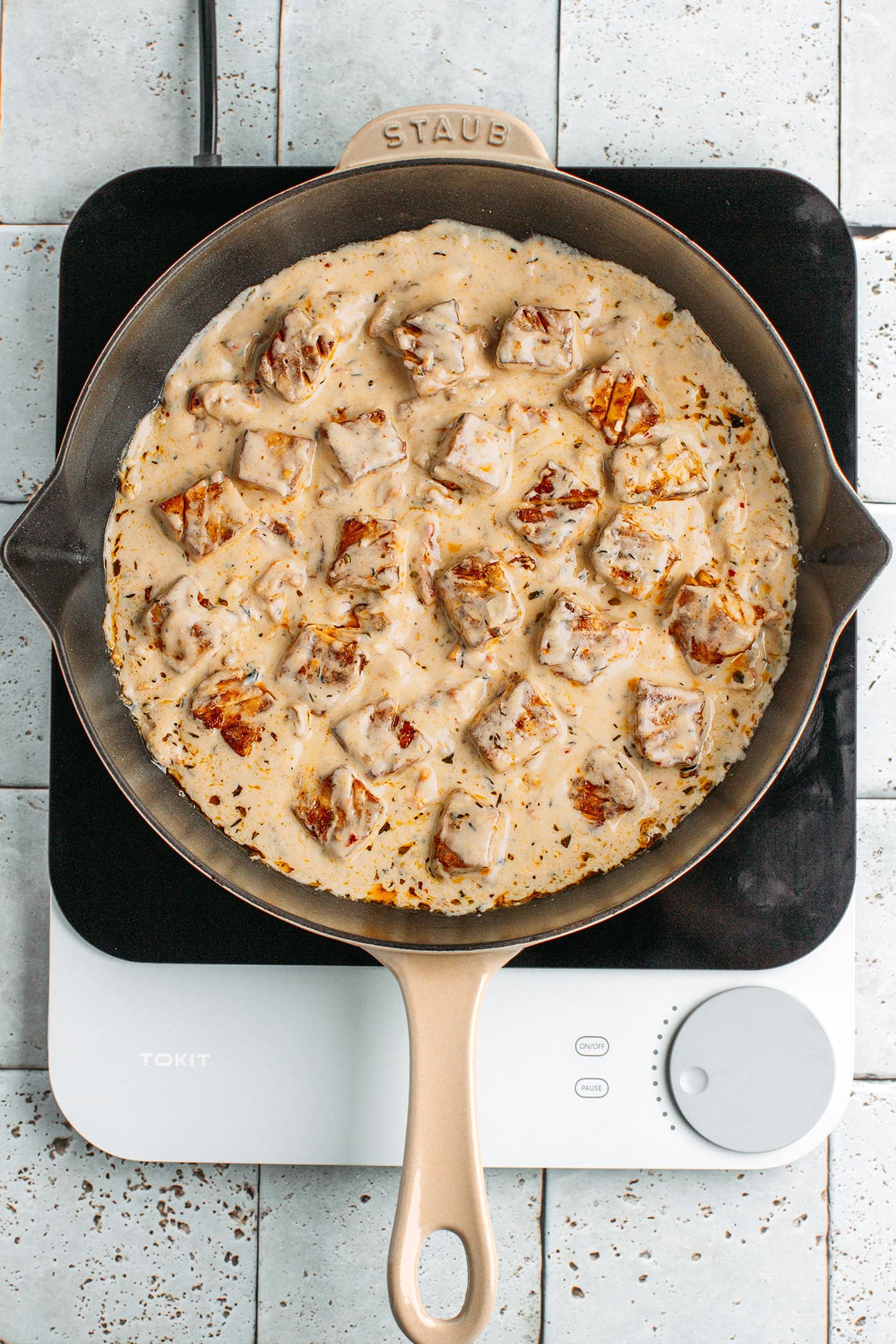 Tofu tossed in Marry Me sauce in a skillet.
