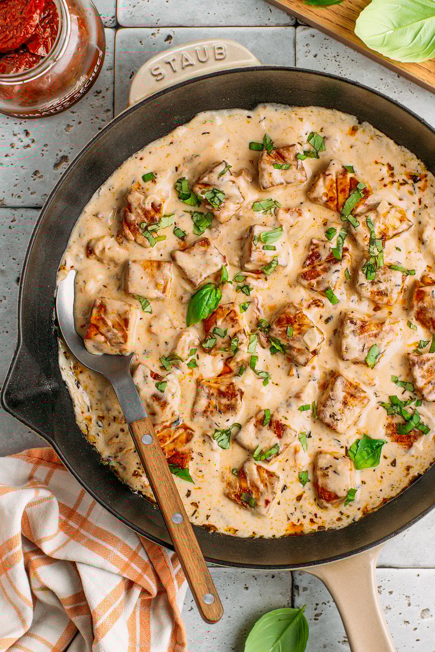 Marry me tofu with baked tofu cubes and cashew sauce in a skillet.