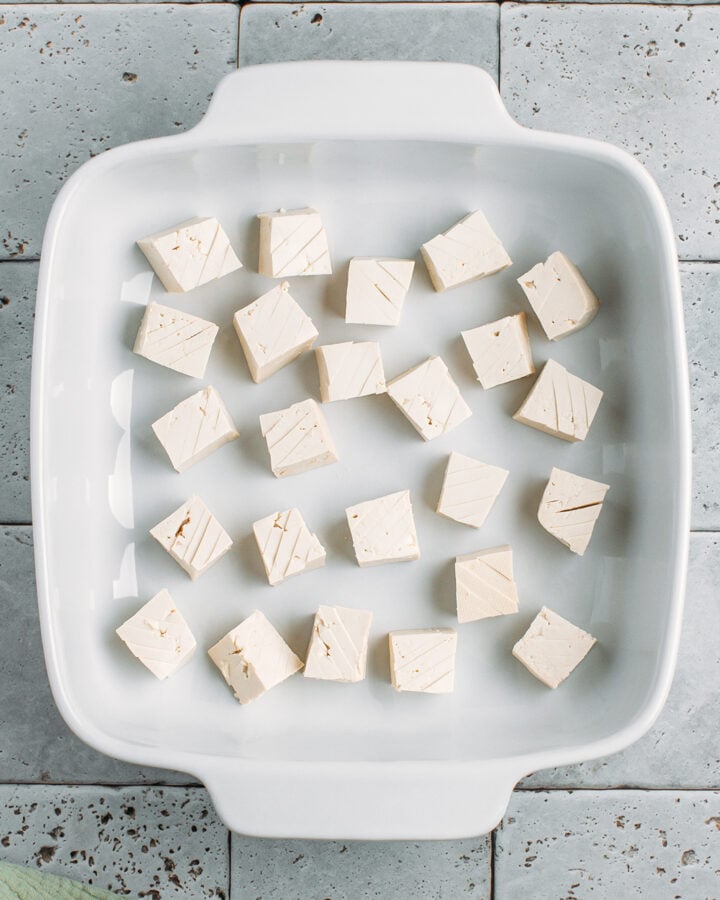 Diced tofu in a baking dish.