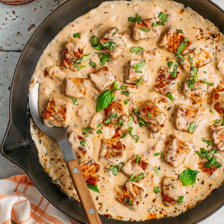 Marry me tofu with baked tofu cubes and cashew sauce in a skillet.