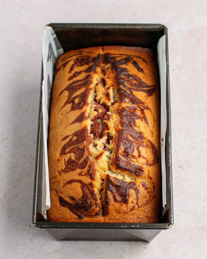 Baked strawberry marble cake in a loaf pan.