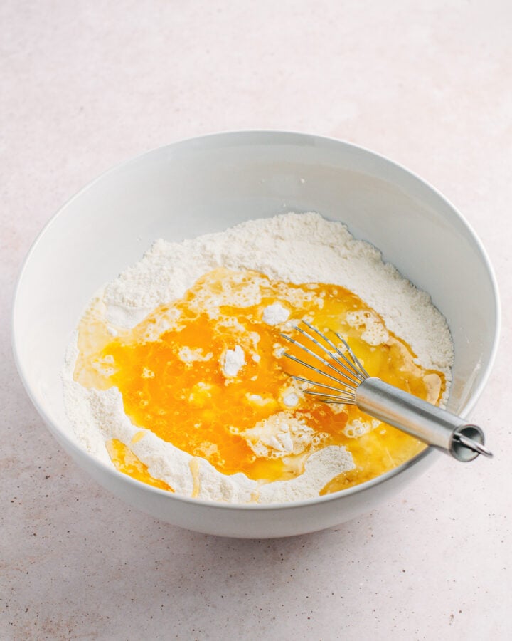 Flour, melted butter, plant-based milk, and oil in a mixing bowl.