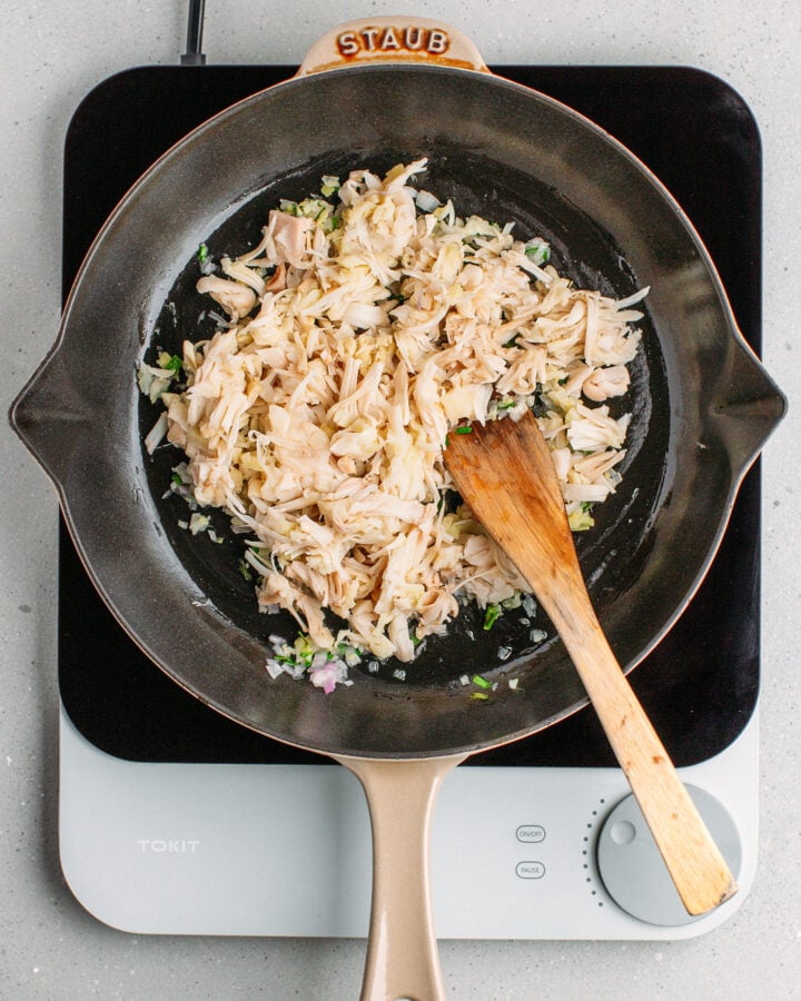 Shredded young green jackfruit in a skillet.