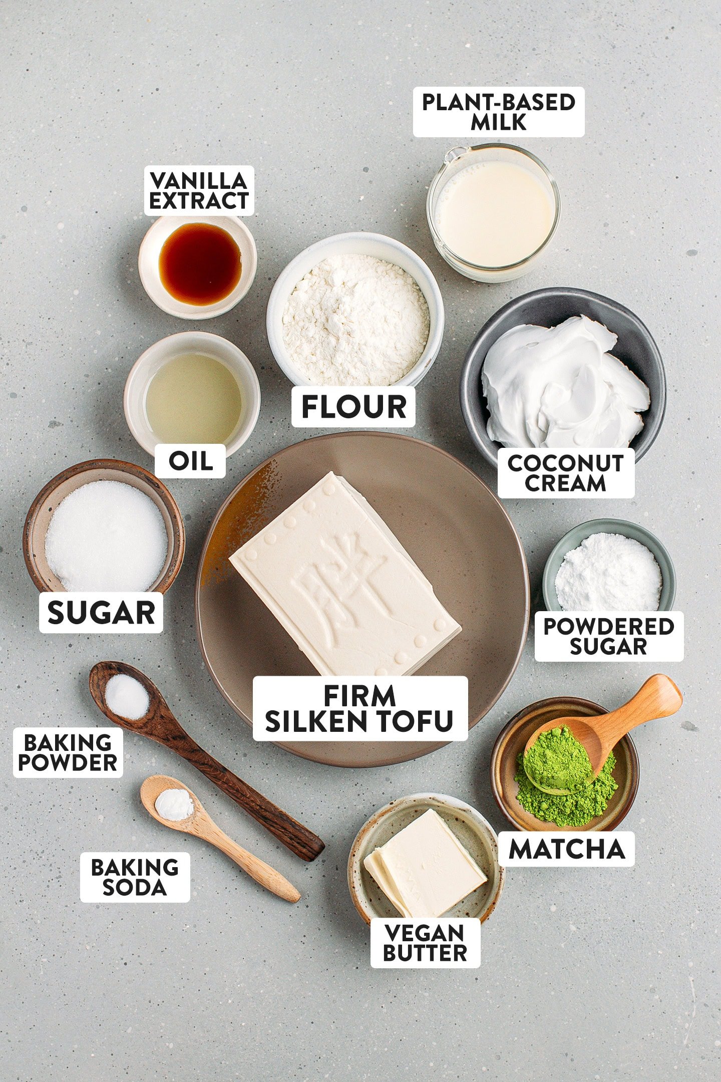 Ingredients like flour, vanilla extract, coconut cream, and matcha powder.