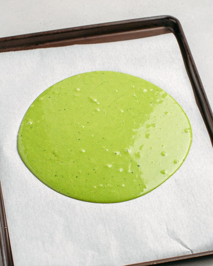 Matcha sponge cake batter on a baking sheet.