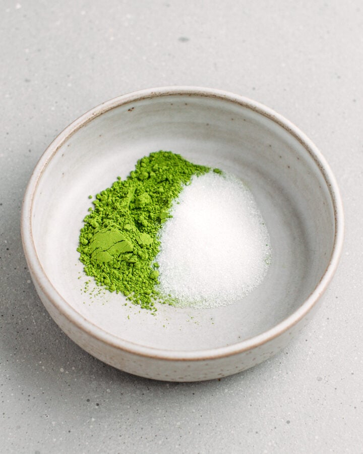 Matcha powder and sugar in a small bowl.