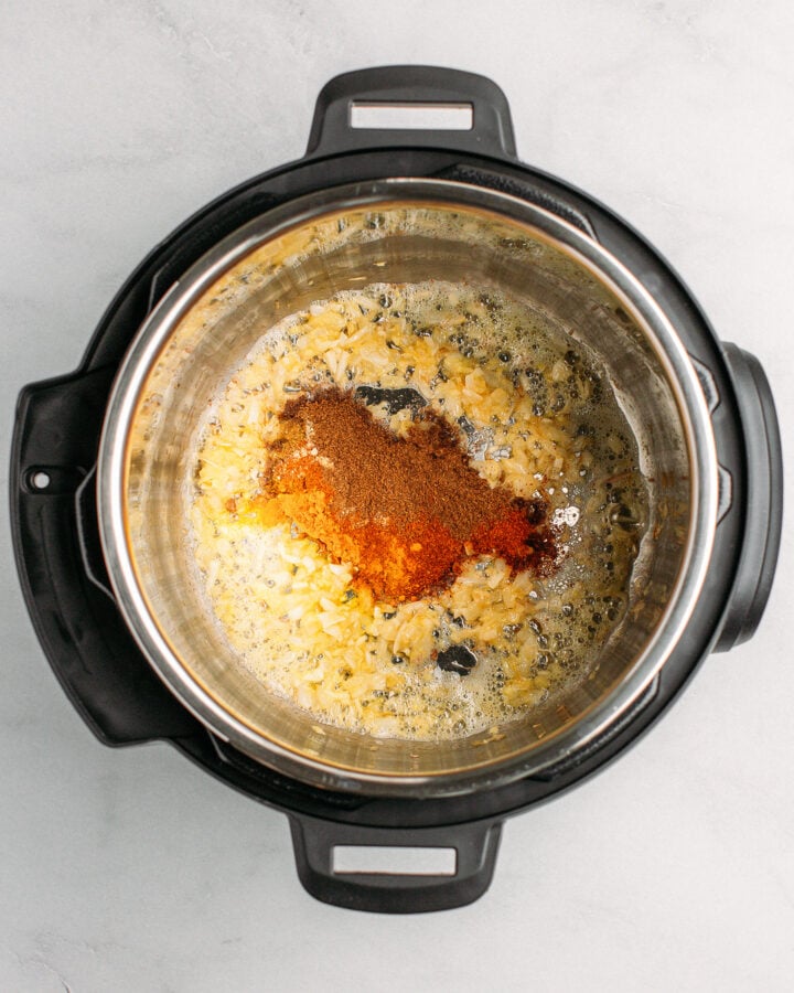 Sautéed onions, garlic, ginger, and spices in an Instant Pot.