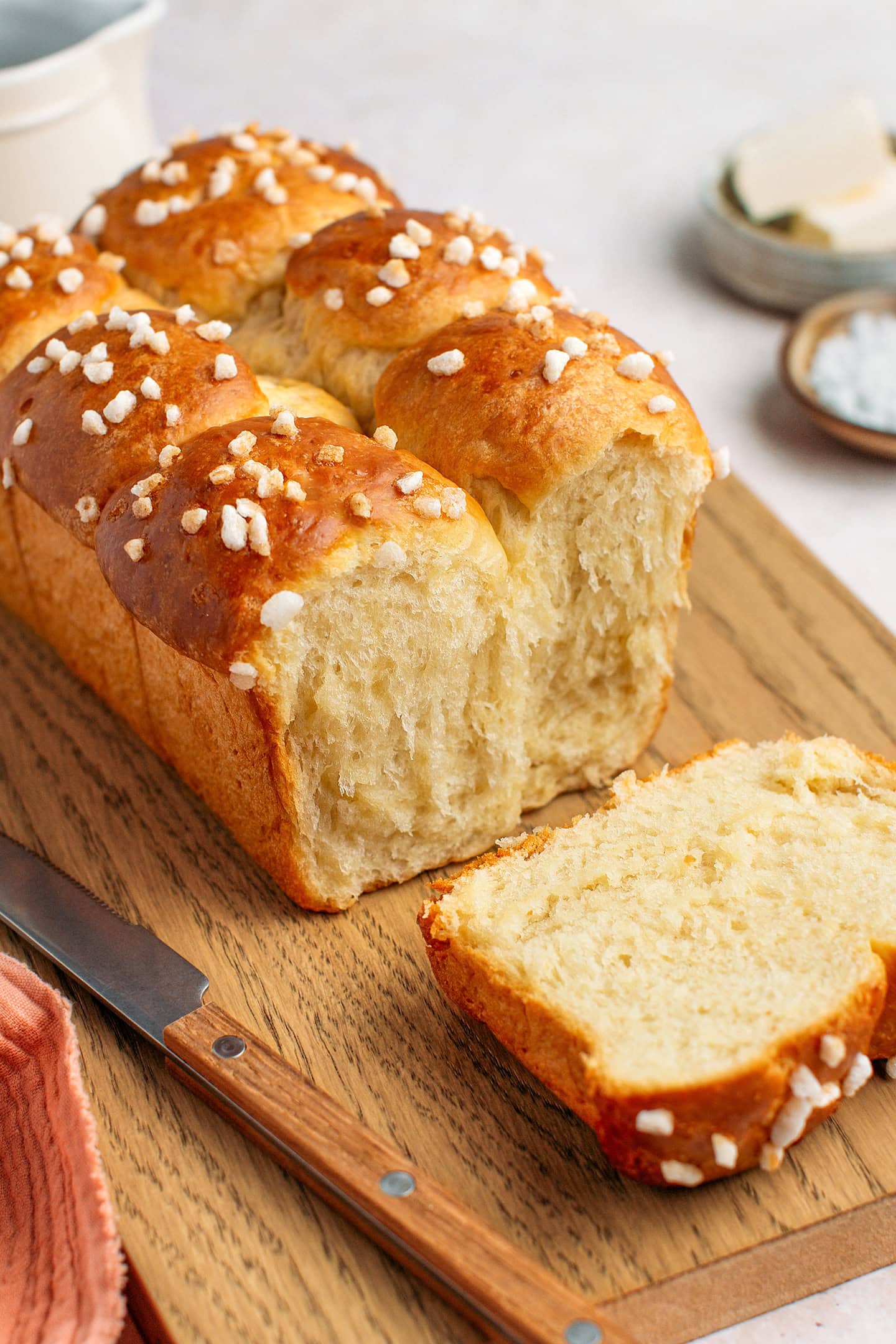 Sliced fluffy brioche on a wood cutting board.
