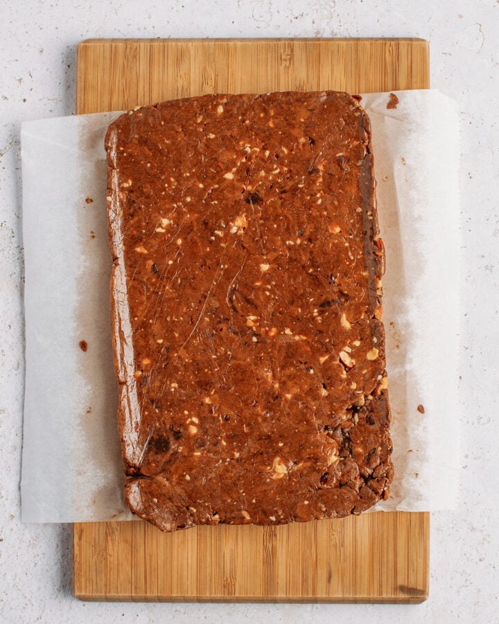 Layer of protein bar mixture on a cutting board.