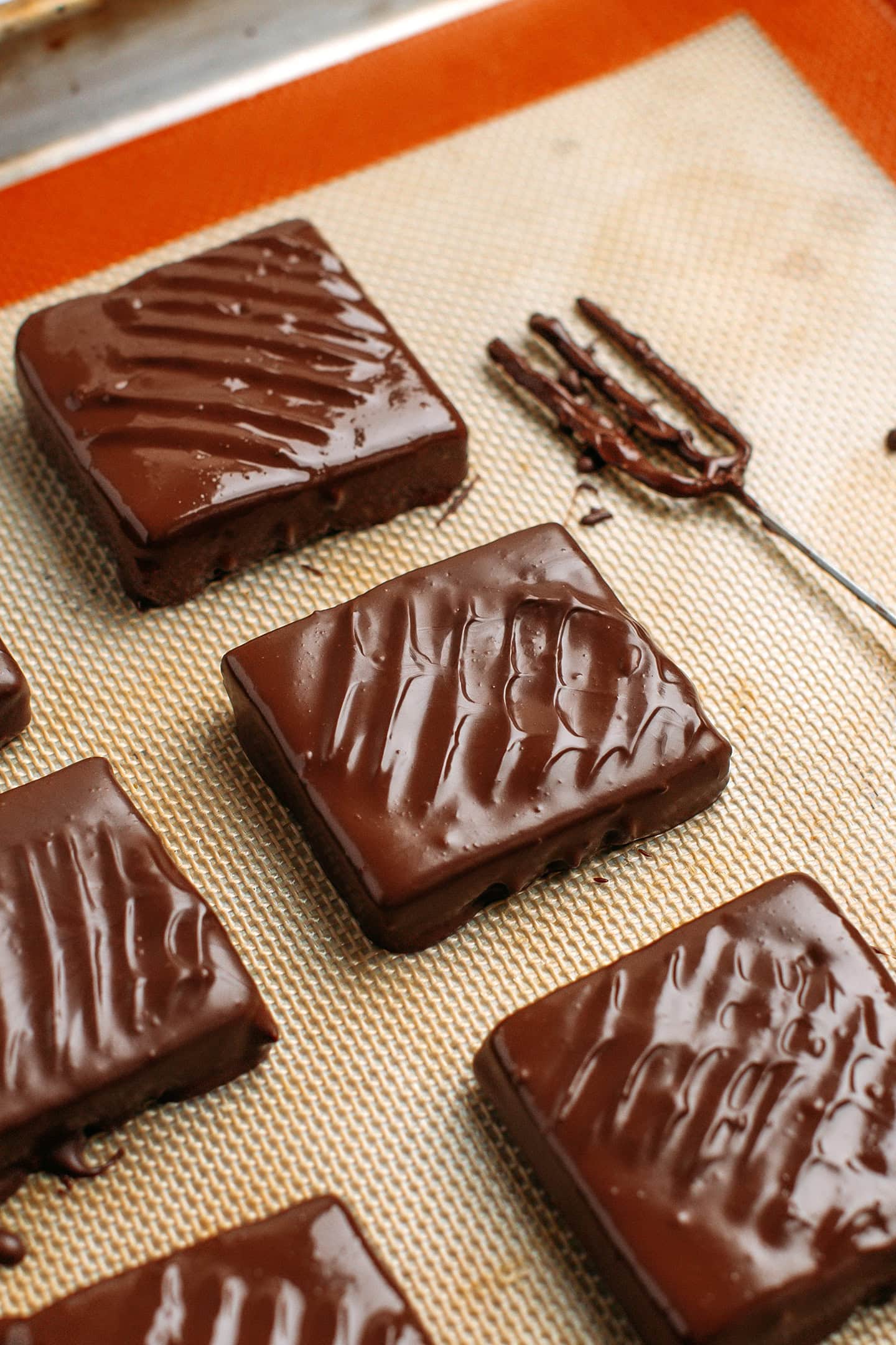 Chocolate-coated protein bars on a silpat.