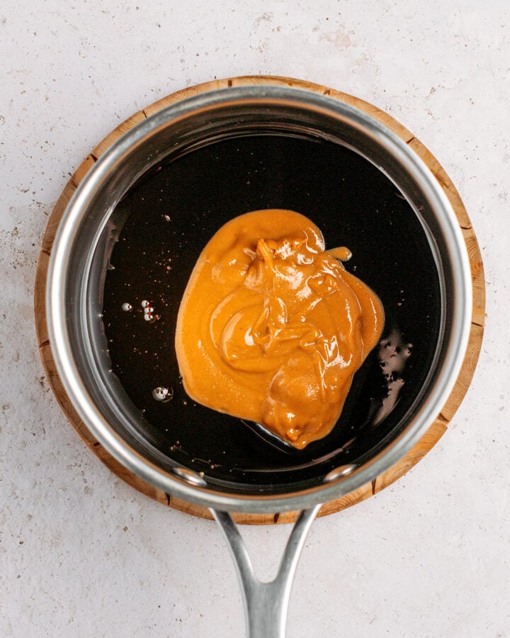 Coconut nectar and almond butter in a saucepan.